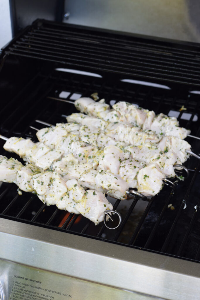 Cooking chicken kebabs on a barbecue.