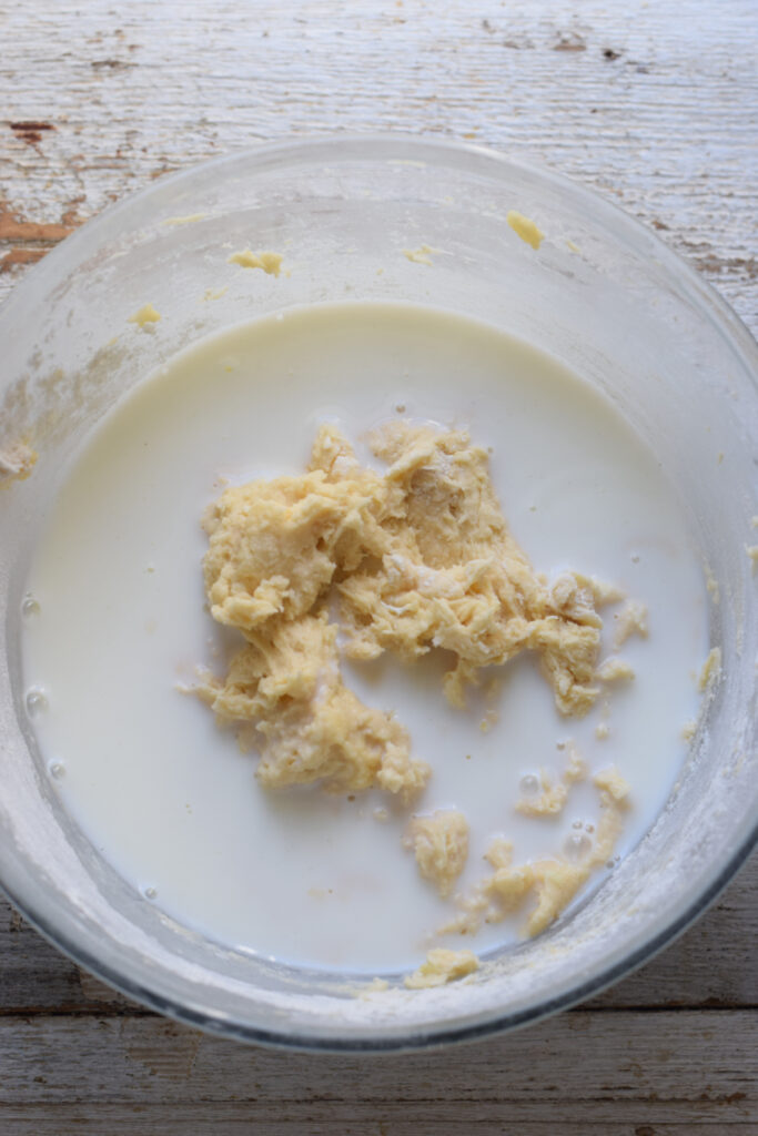 Adding milk to muffin batter.