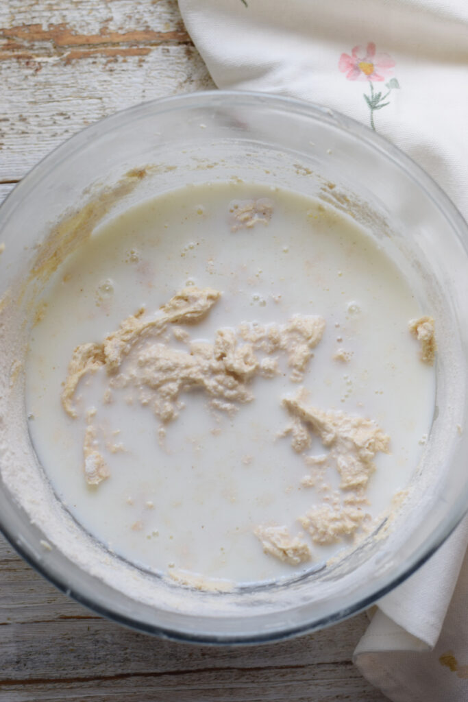 Adding buttermilk to cake batter.