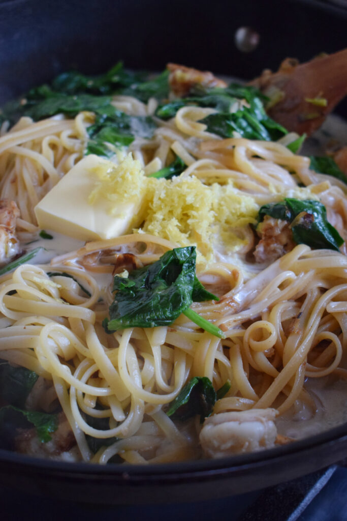 Lemon cream spaghetti in a skillet.