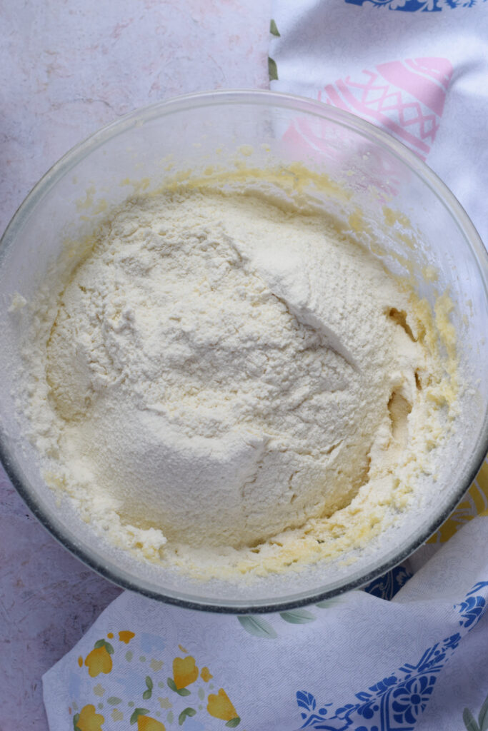 Adding flour to cookie dough.