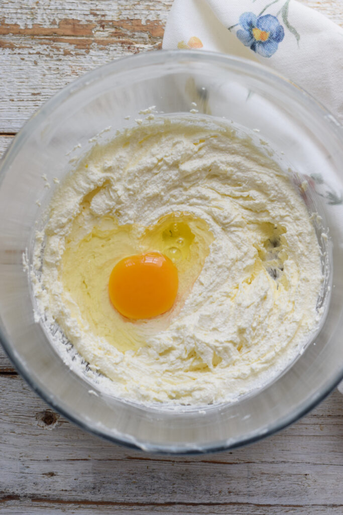 Adding eggs to cake batter.