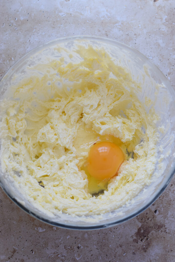 Adding eggs to muffin batter.