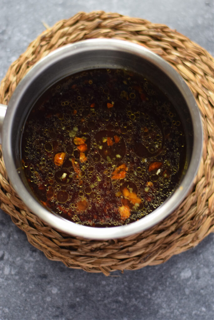 Cooking honey garlic sauce in a saucepan.