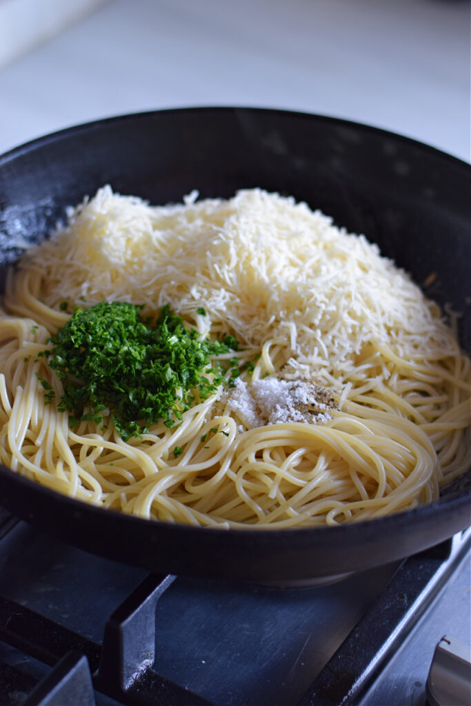 Combine parmesan cheese with spaghetti.