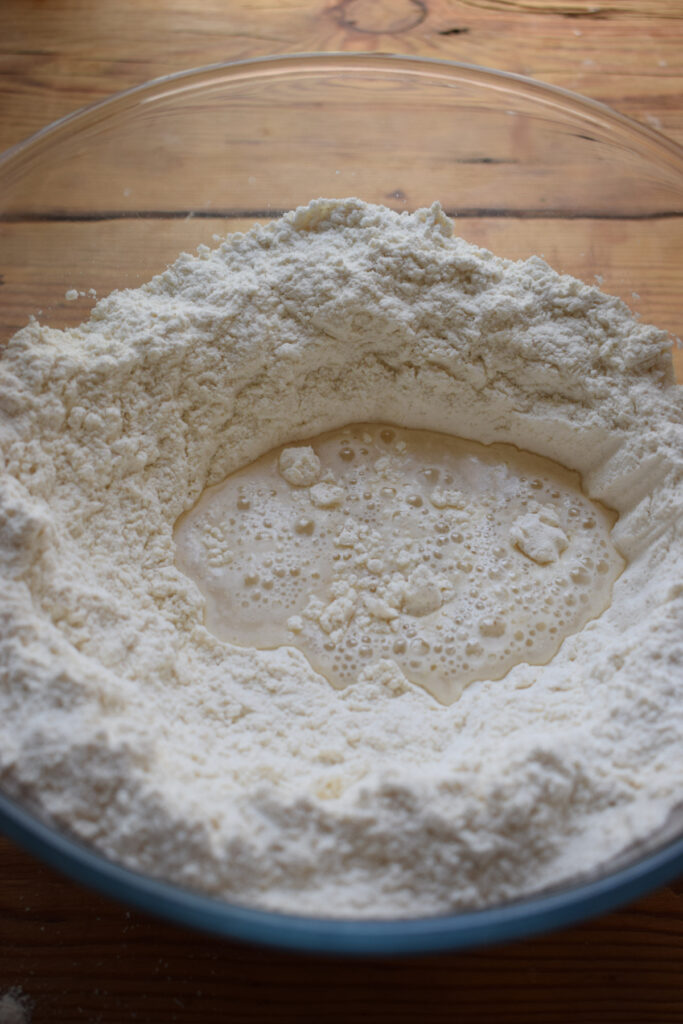 Adding water to bread flour.