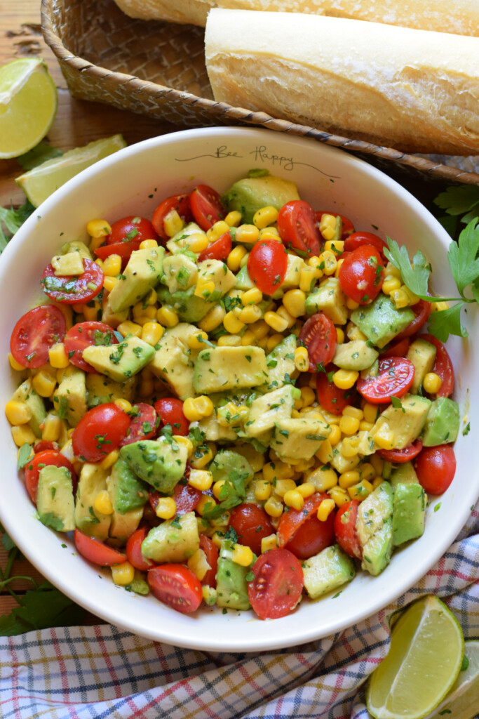 Avocado corn salad in a white bowl.