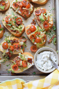 Bruschetta on a tray with a cream cheese spread.