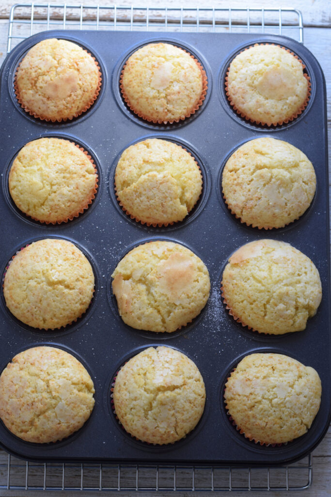 Baked lemon muffins in a tray.