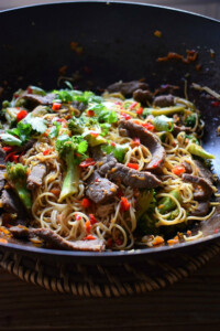 Beef and broccoli noodle stir fry in a wok