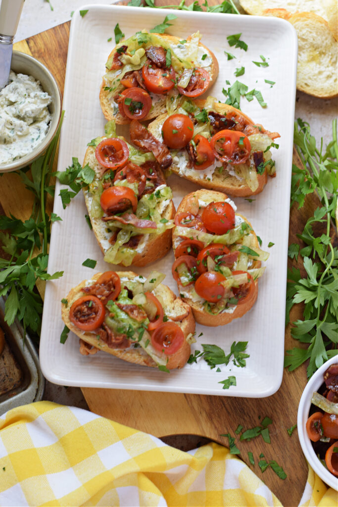Blt bruschetta on a white plate.