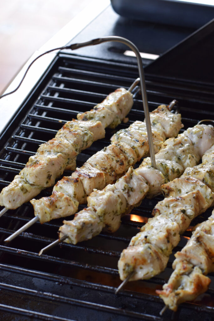 Cooking chicken skewers on a barbecue.