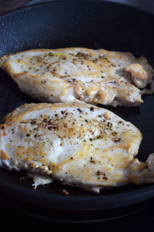 Browning chicken in a skiillet.