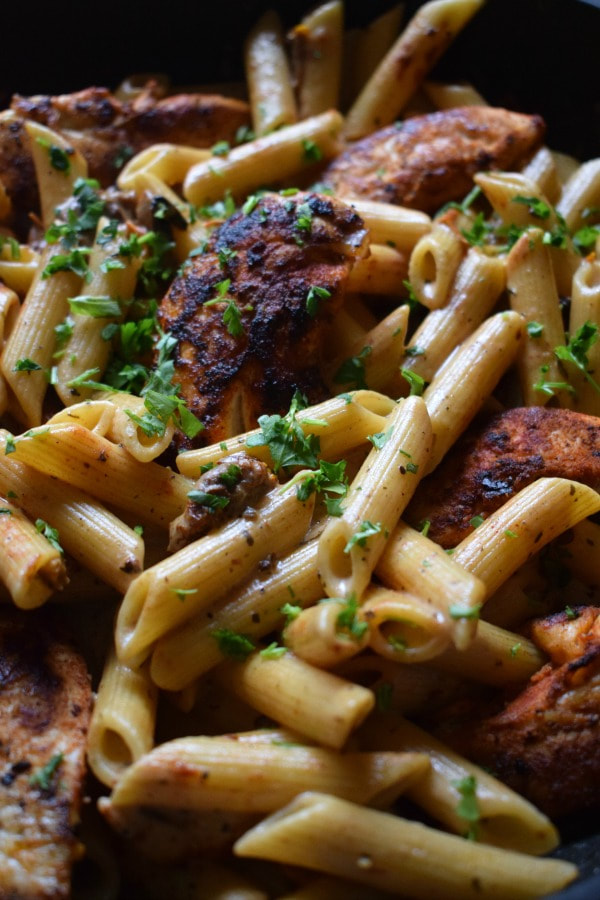 creamy sun dried pasta with chicken in a skillet