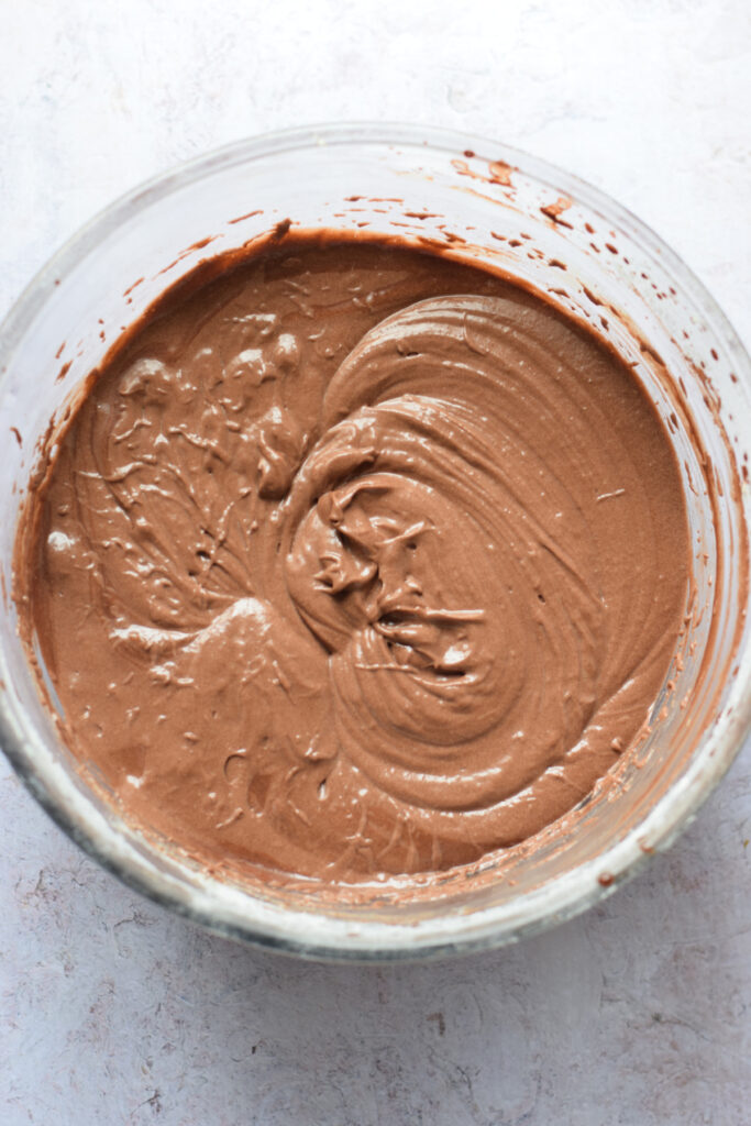 Chocolate cupcake batter in a glass bowl.