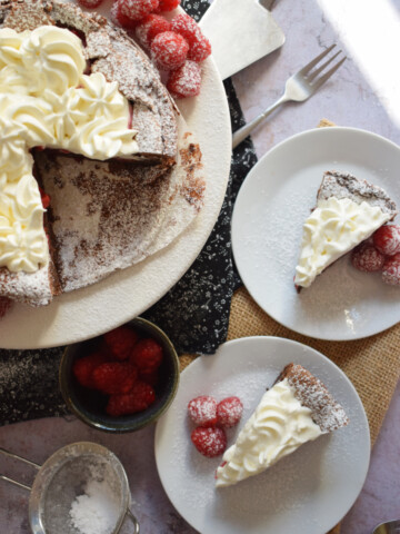Slices of chocolate and raspberry cake on plates.