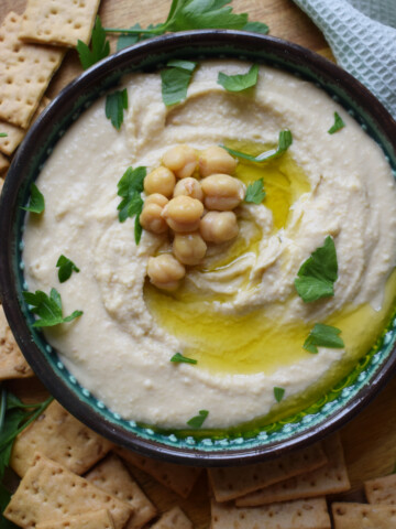 Hummus in a bowl with chickpeas.