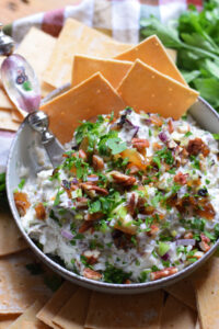 Goat cheese dip in a bowl with crackers.