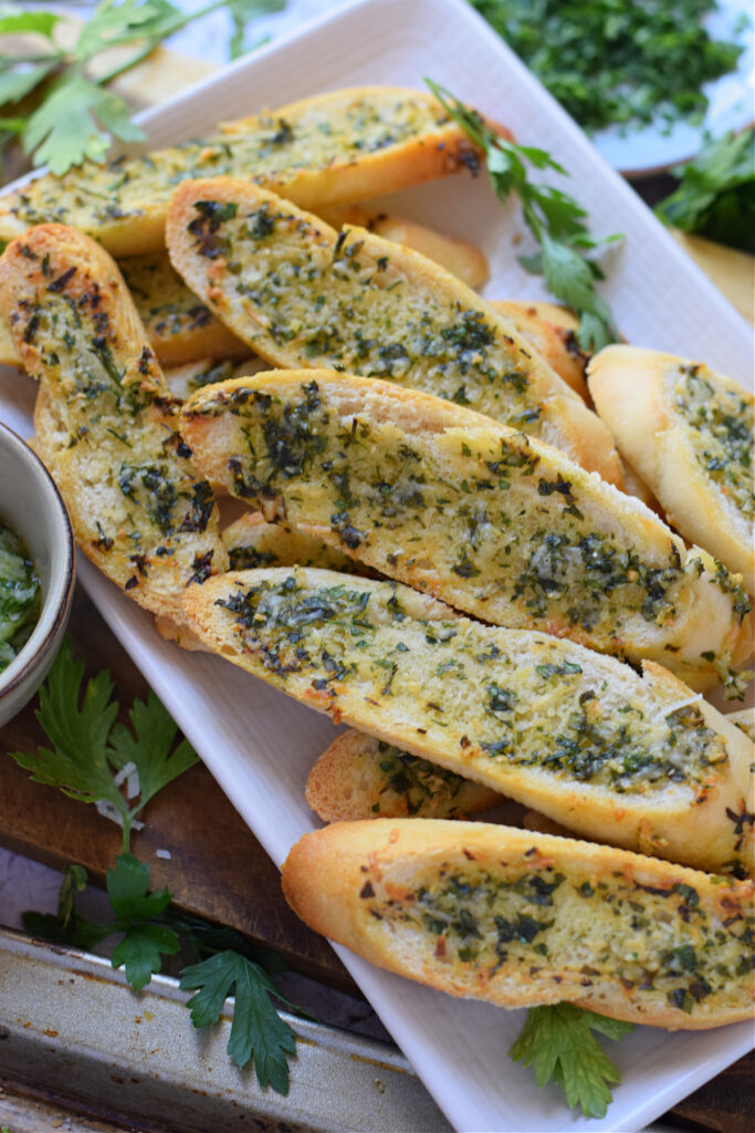Garlic parmesan crostini on a white plate.