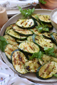 Close up of zucchini on a white plate.
