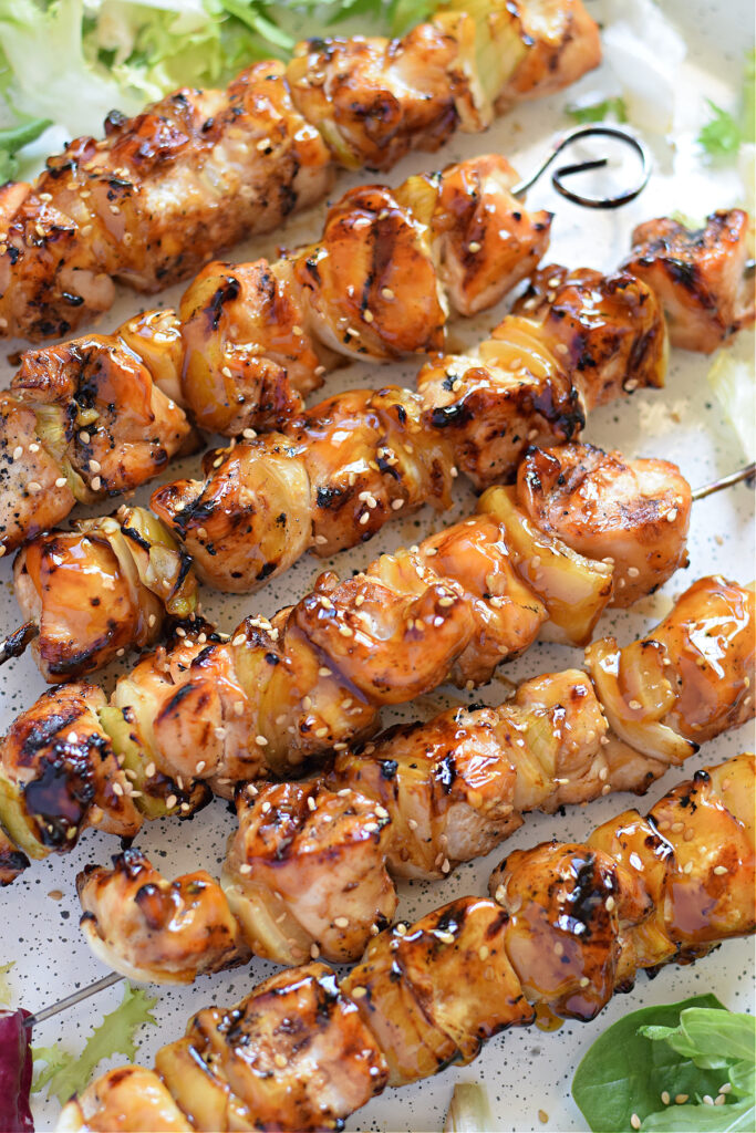 Close up of teriyaki chicken skewers.