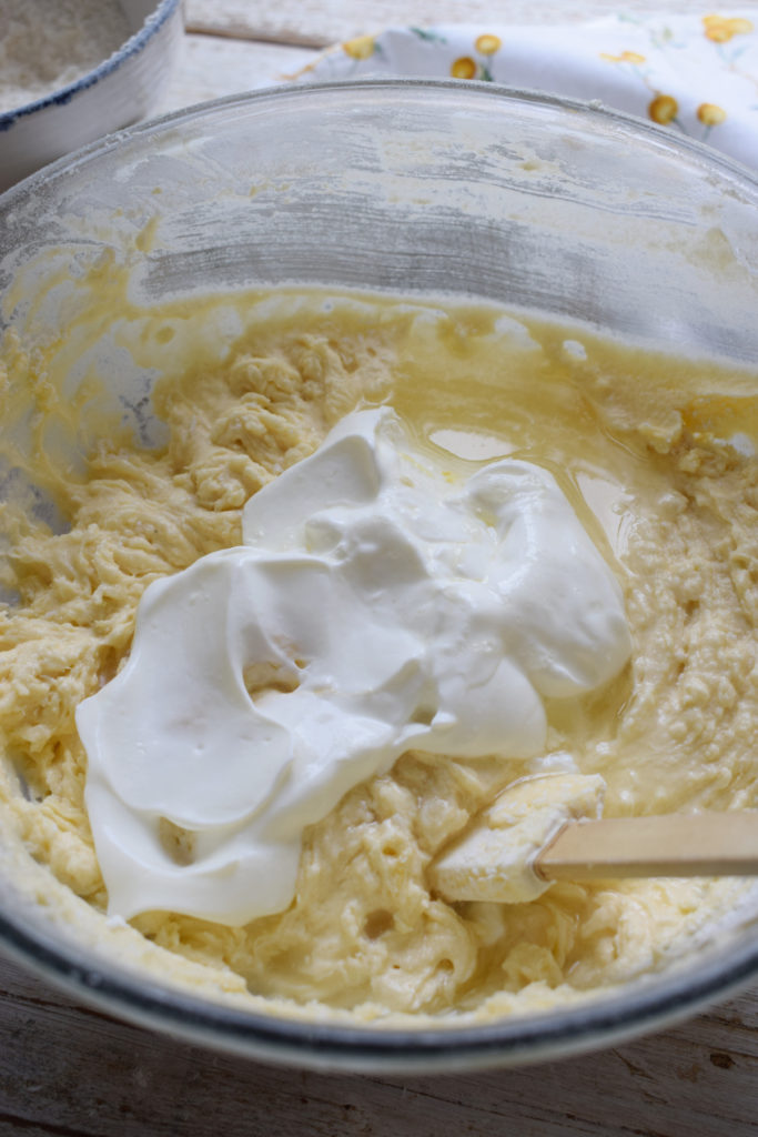 Adding yogurt and lemon juice to the batter.