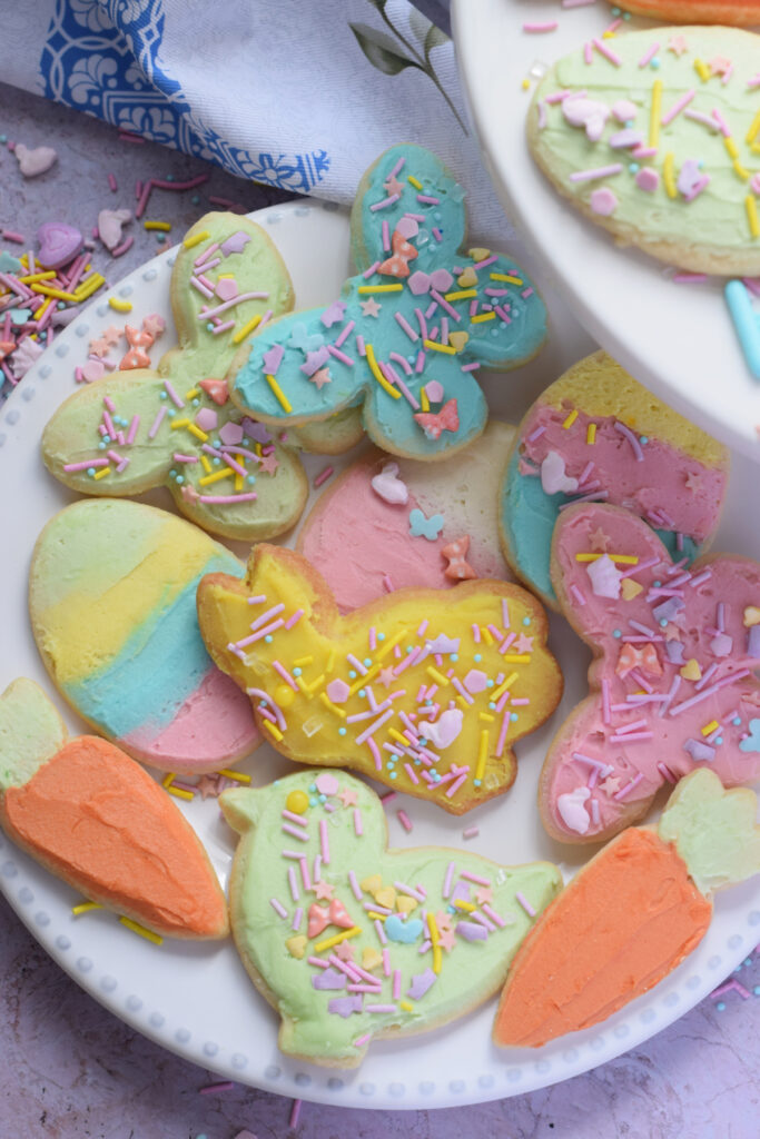 Frosted cookies for Easter on a white plate.