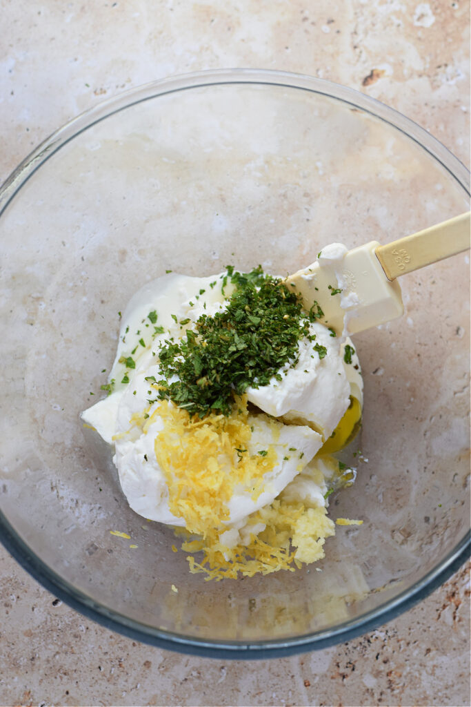 Ingredients in a glass bowl to make a dip.