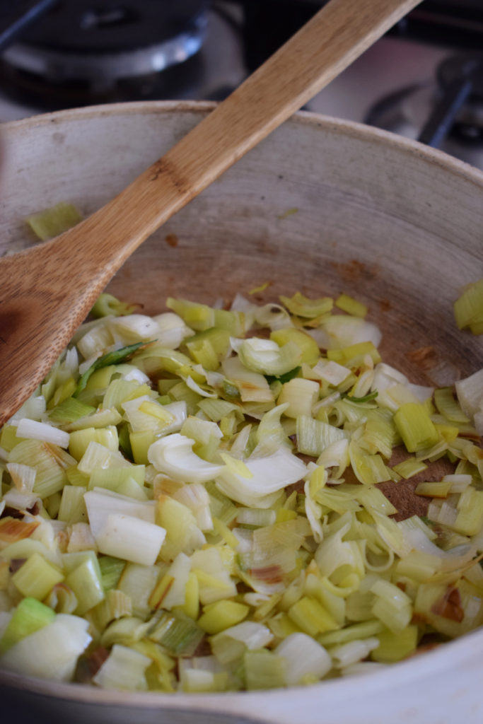 Cooking leeks in a skillet.