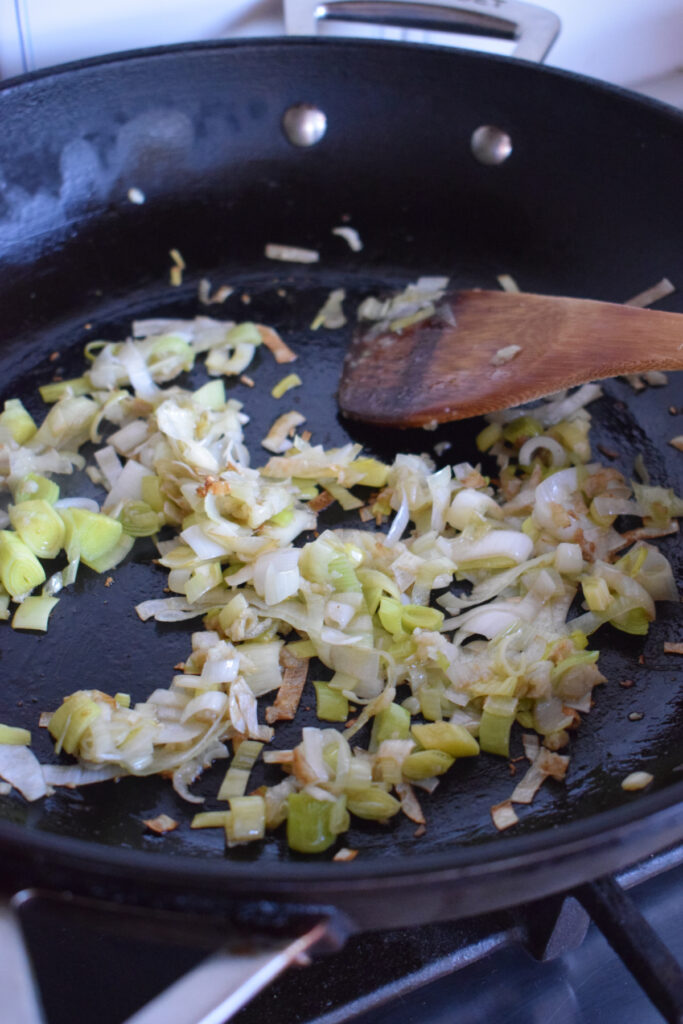 Cooking leeks in a skillet.