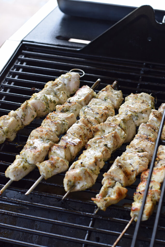 Cooking chicken skewers on a barbecue.