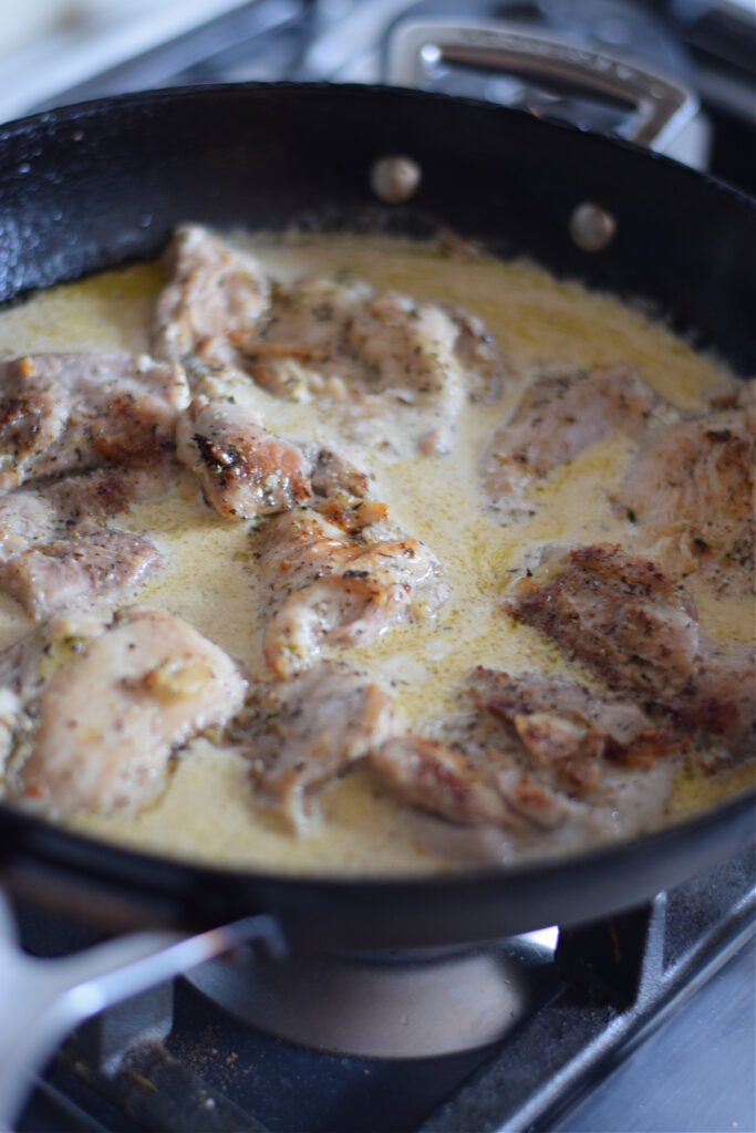 Cooking chicken in a lemon cream sauce.