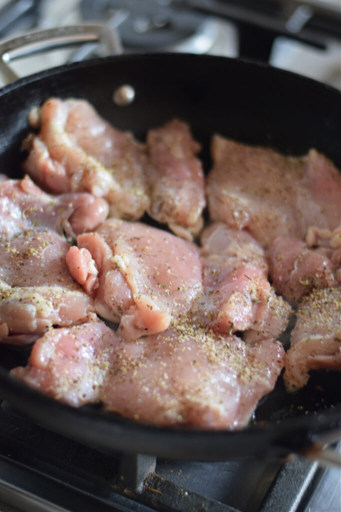 Cooking chicken in a skillet.
