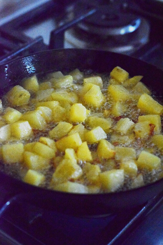 Cooking potatoes in a skillet.
