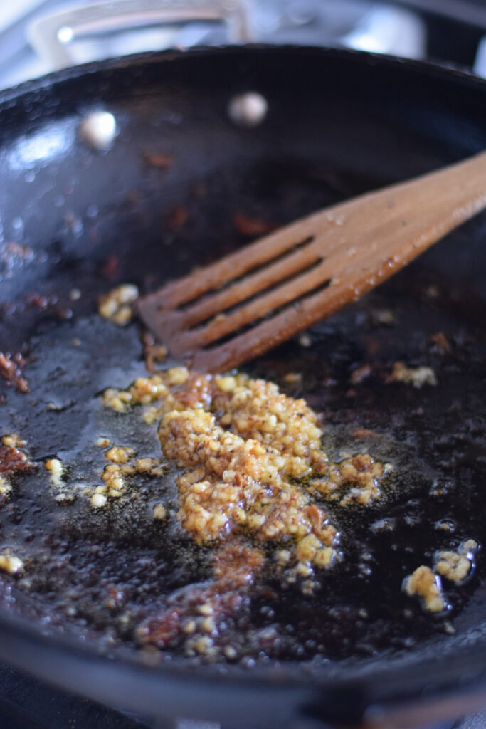 Cooking garlic in a skillet.