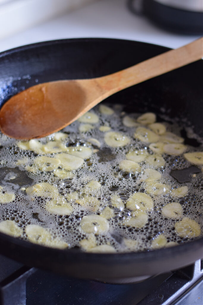 Cooking garlic in a skillet.