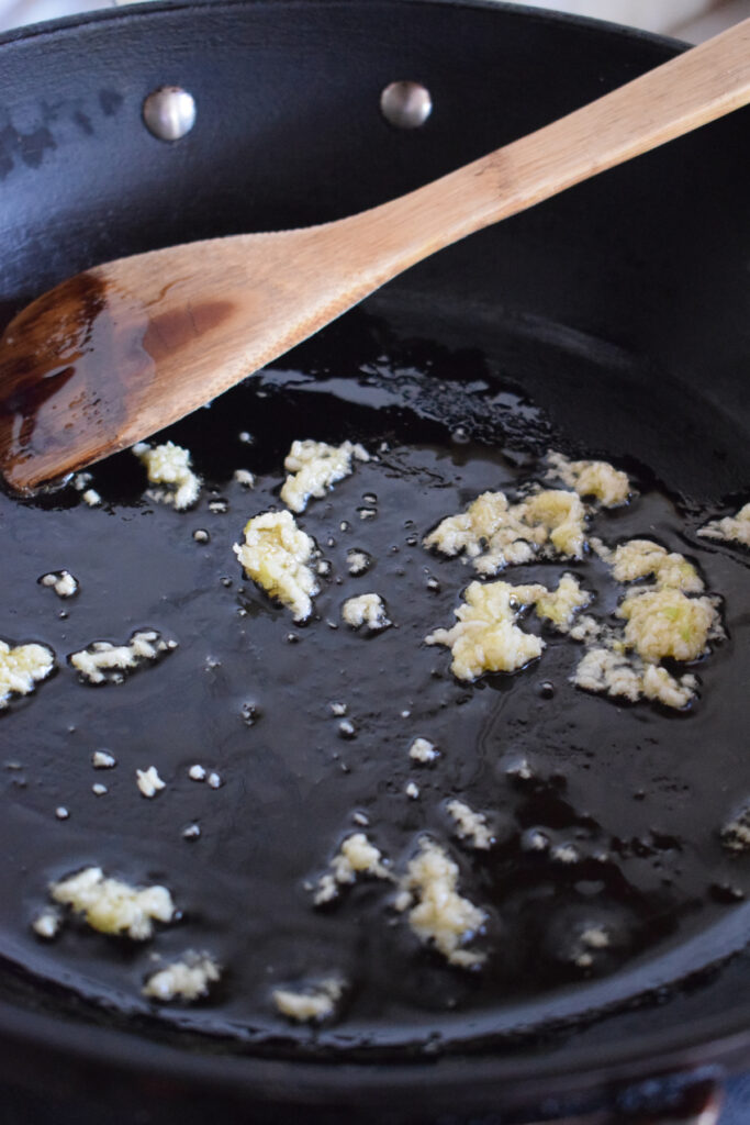Cooking garlic in a skillet.