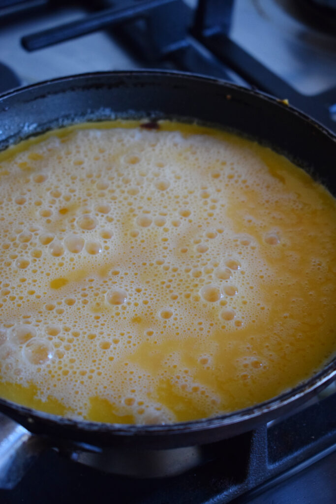 Cooking eggs in a skillet.