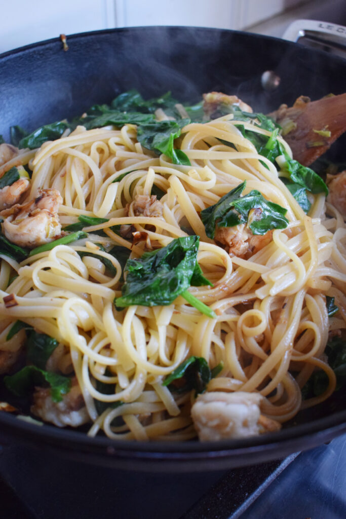 Creamy shrimp and pasta in a skillet.