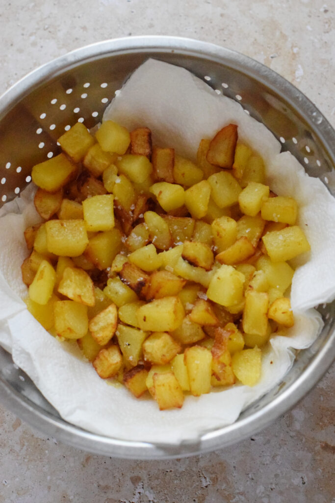 Draining potatoes on paper towels.