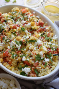Lemon herb couscous salad in a white bowl.