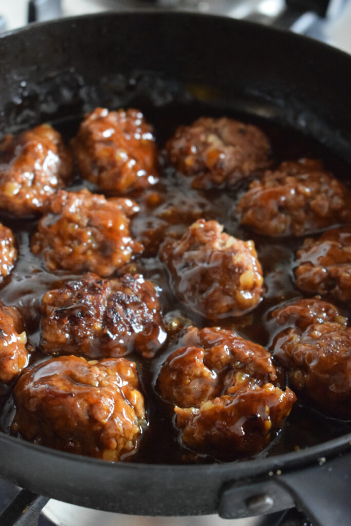 Cooking meatballs in teriyaki sauce.