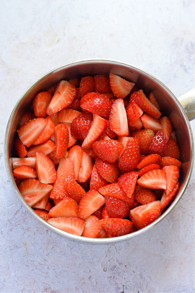 Sliced strawberries in a saucepan.