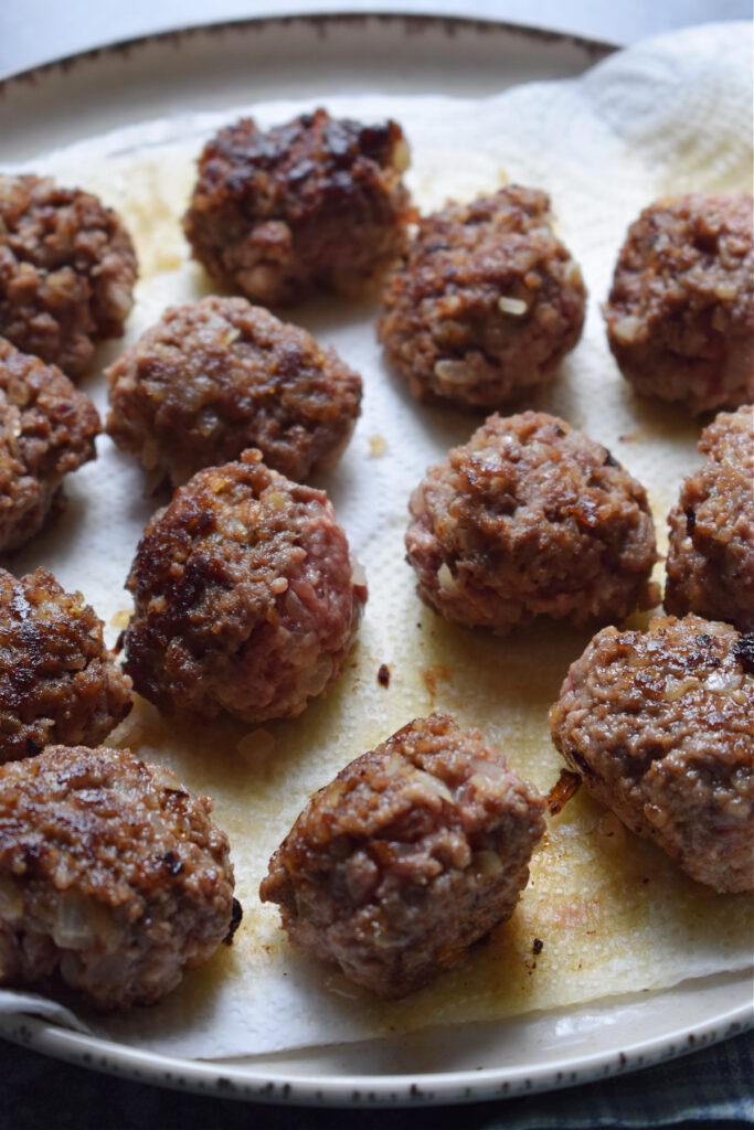 Draining meatballs on paper towels.