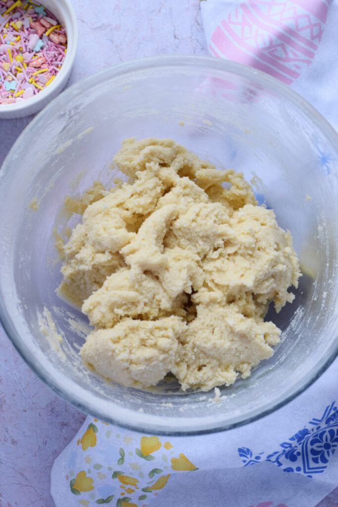 Sugar cookie dough in a glass bowl.