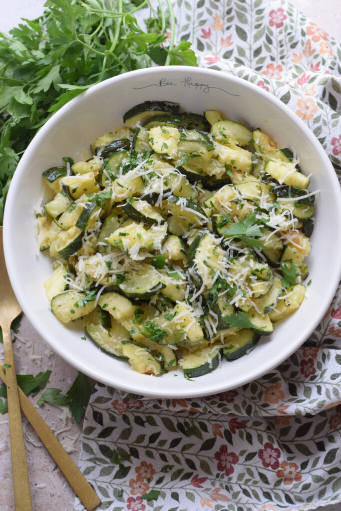 Parmesan topped zucchini in a bowl.