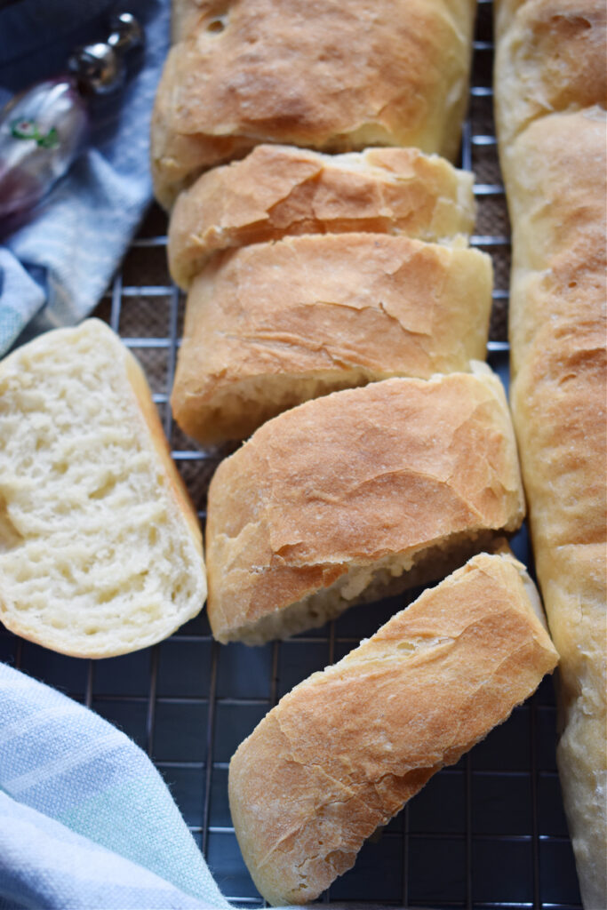 Sliced bread on a try with a tea towel.