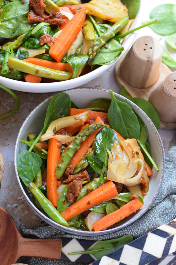 Spring vegetable stir fry in a serving bowl.