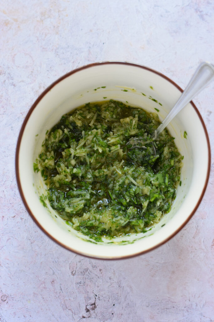 A garlic parsley topping in a small bowl.
