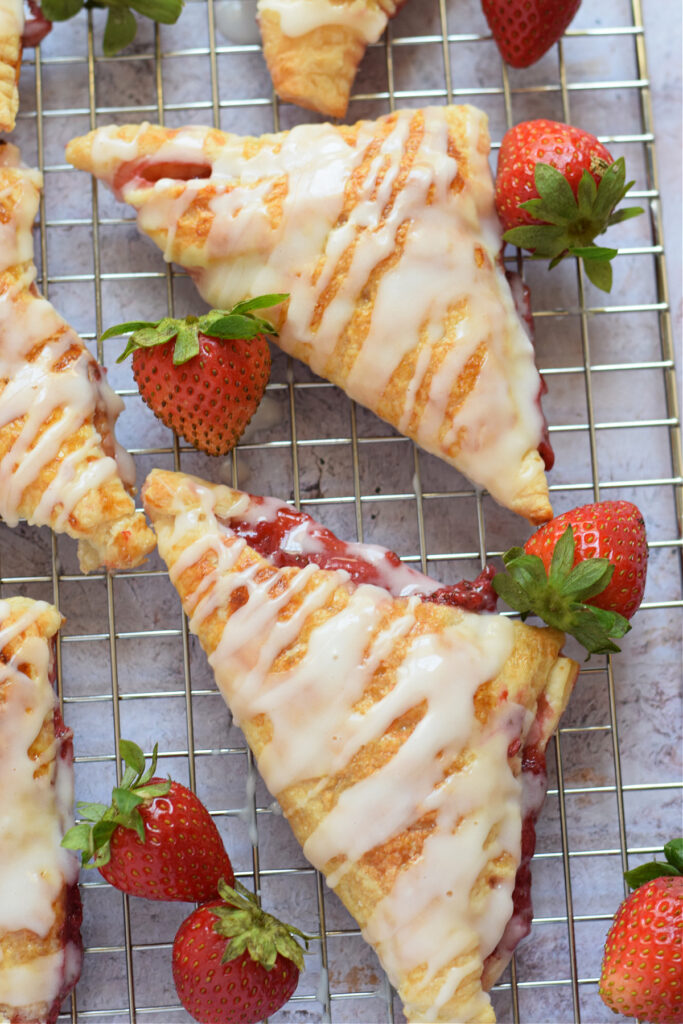 Pastry turnovers on a baking tray.